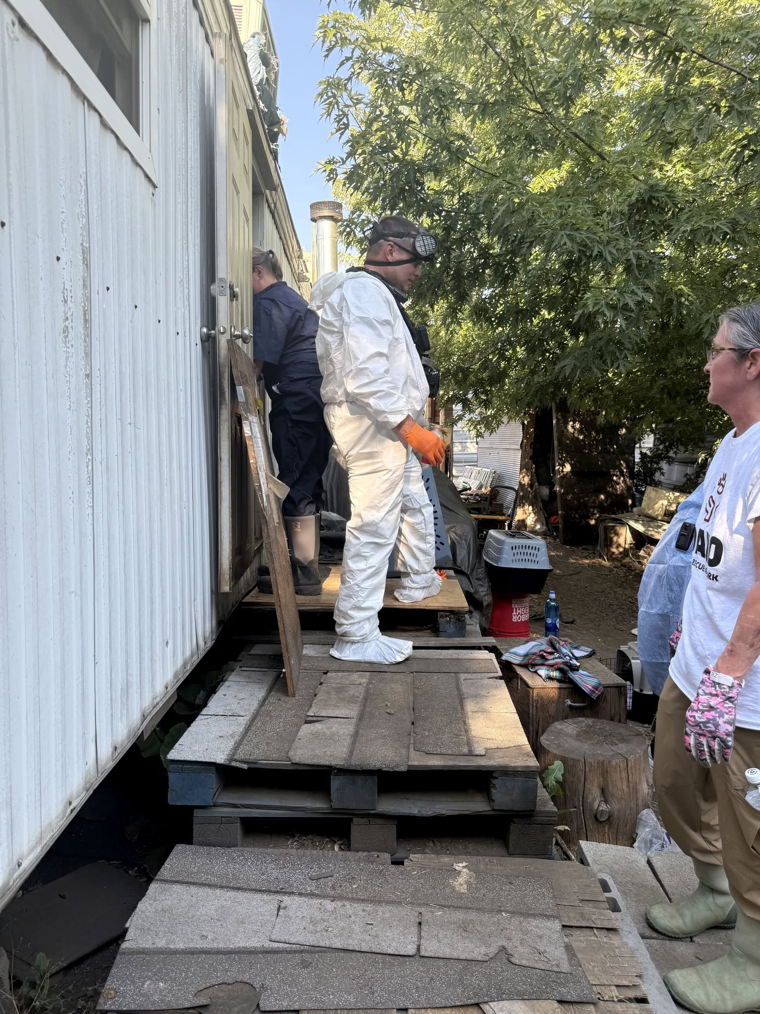 Animal welfare responders in protective gear at an Idaho property
