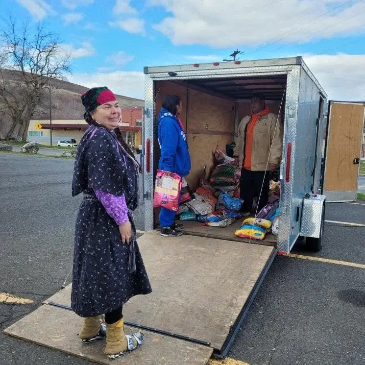IARN volunteer helping distribute pet supplies from the rescue trailer